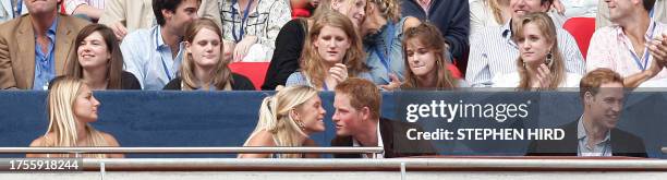 Britain's Prince Harry talks to his girlfriend Chelsy Davy at Wembley Stadium in London for the "Concert for Diana", held in memory of their mother...