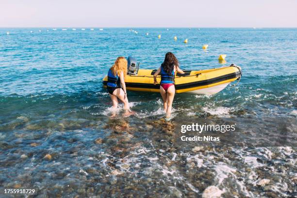 beach with yellow marine buoys limiting the water scooter zone - active lifestyle icons stock pictures, royalty-free photos & images