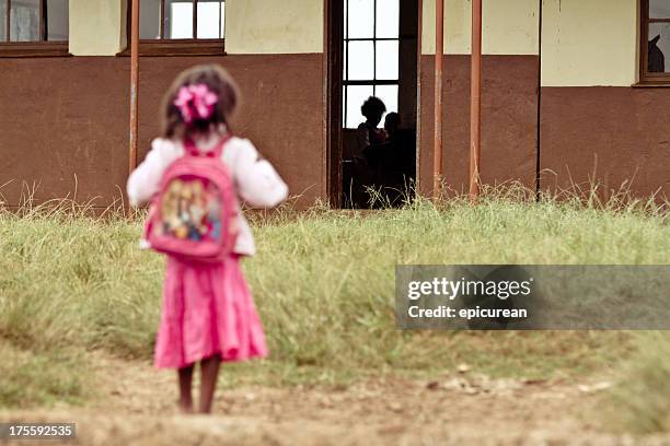 young african girl nervous on her first day of school - african school kids stockfoto's en -beelden