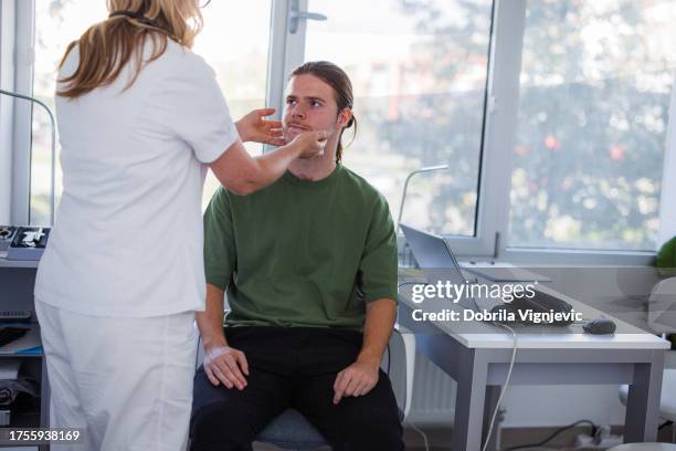 überprüfung der schilddrüsen beim arzt - infectious mononucleosis stock-fotos und bilder