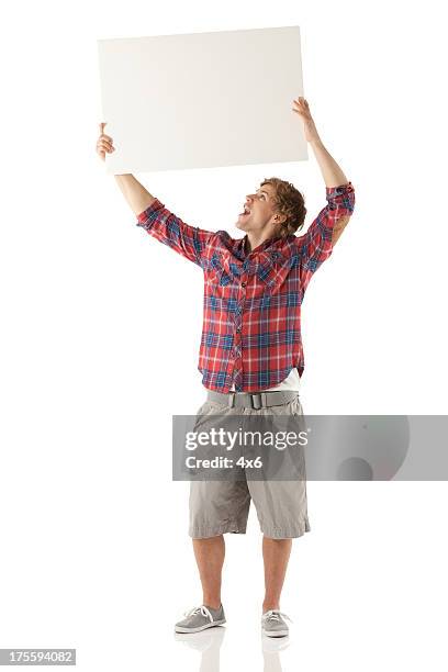 man holding up a placard - omhoog houden stockfoto's en -beelden