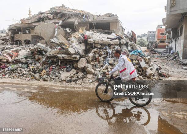 Dr. Hassan Zein Al-Din rides his bicycle to the United Nations school to treat people displaced by the war in the Al-Bureij camp in the central Gaza...