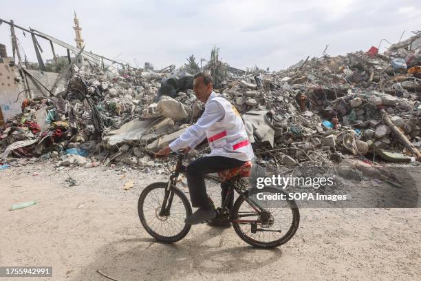 Dr. Hassan Zein Al-Din rides his bicycle to the United Nations school to treat people displaced by the war in the Al-Bureij camp in the central Gaza...