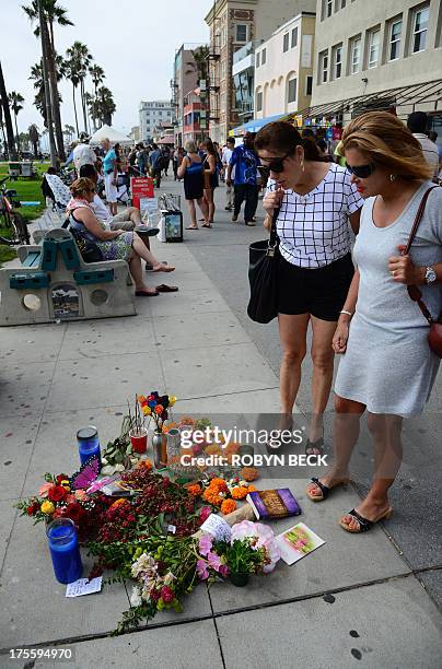 Passersby stop to view a memorial to 32-year-old Italian newlywed Alice Gruppioni on the Venice Beach boardwalk on August 4, 2013. One day earlier,...