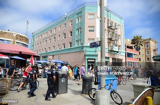 Los Angeles police patrol on the Venice Beach boardwalk on August 4, 2013. One day earlier, 32-year-old Italian newlywed Alice Gruppioni was killed...