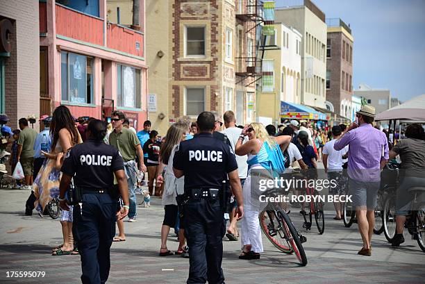 Los Angeles police patrol on the Venice Beach boardwalk on August 4, 2013. One day earlier, 32-year-old Italian newlywed Alice Gruppioni was killed...