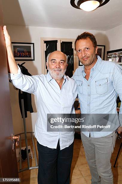 Actor Gerard Jugnot and presenter Arthur after "Cher Tresor" on day 5 of the 29th Ramatuelle Festival on August 4, 2013 in Ramatuelle, France.