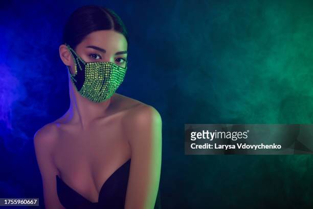 photo of chic gorgeous lady wear face mask over misty neon background in rave modern disco night club - colar de diamantes fotografías e imágenes de stock