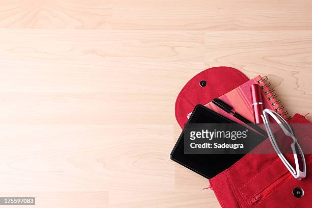 digital tablet in  woman's bag backpack - red purse stock pictures, royalty-free photos & images