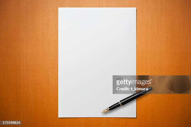 blank paper on desk with a pen - message stock pictures, royalty-free photos & images
