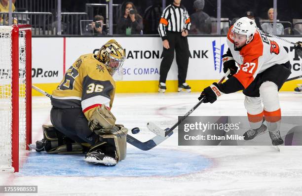 Logan Thompson of the Vegas Golden Knights makes a save against Noah Cates of the Philadelphia Flyers in the third period of their game at T-Mobile...