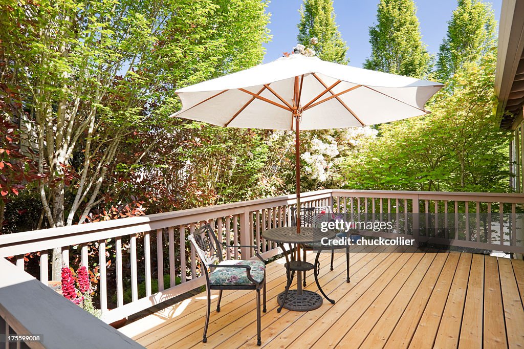 Sunny second floor back deck with breakfast table