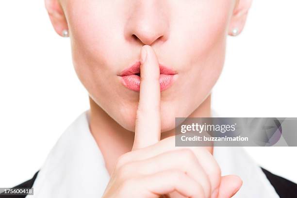 silence! - woman with finger on lips stock pictures, royalty-free photos & images