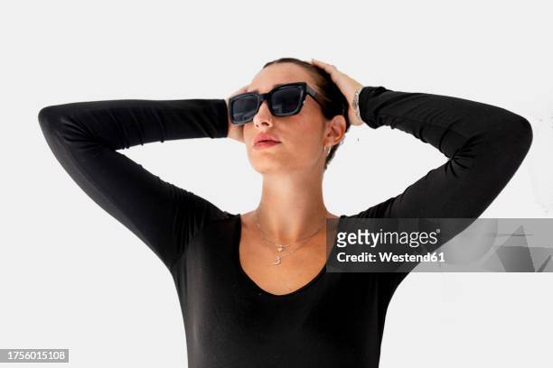 beautiful woman wearing sunglasses against white background - women in see through tops stock pictures, royalty-free photos & images