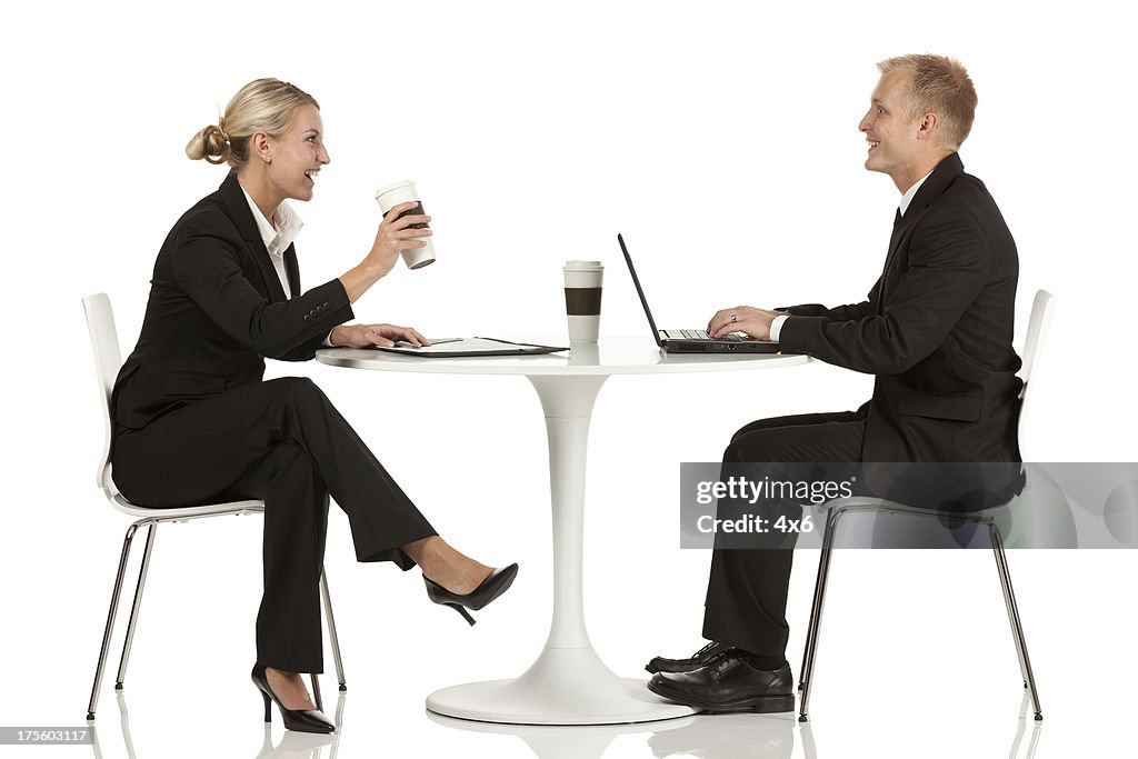 Business executives sitting across from one another at a table