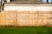 A hard wood fence outside a house