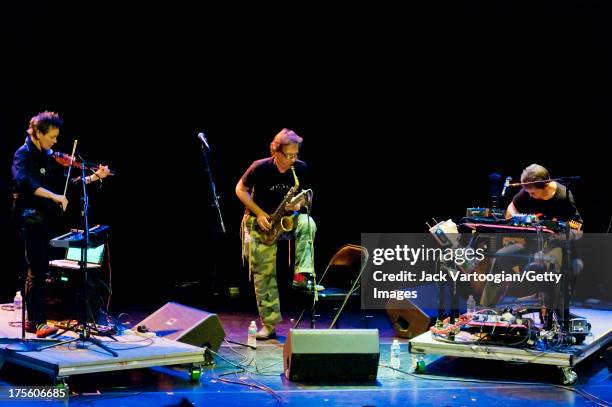 From left, American musicians Laurie Anderson, on violin, John Zorn, on alto saxophone, and Lou Reed, on guitar and electronics, perform at the...