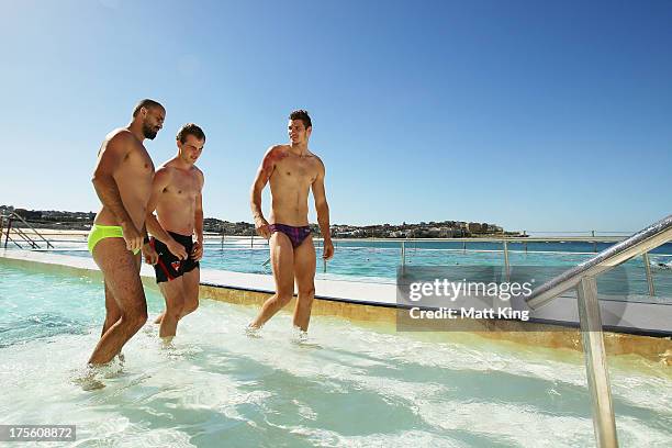 Rhyce Shaw, Tom Mitchell and Andrejs Everitt leave the pool during a Sydney Swans AFL recovery session at Bondi Icebergs Pool on August 5, 2013 in...