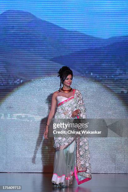 Pooja Kumar walks the runway in an Auro Gold design on day 1 of India International Jewellery Week 2013 at the Hotel Grand Hyatt on August 4, 2013 in...