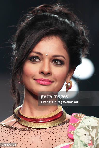 Pooja Kumar walks the runway in an Auro Gold design on day 1 of India International Jewellery Week 2013 at the Hotel Grand Hyatt on August 4, 2013 in...