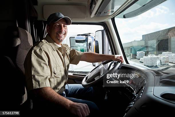 truck driver sitting in cab of semi-truck - truck driver stock pictures, royalty-free photos & images