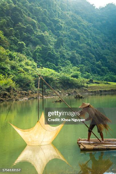 view of fishermen fishing on river in thung mountain in tra linh, cao bang province, vietnam with lake, cloudy, nature - cao bang stock pictures, royalty-free photos & images