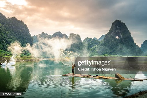 view of fishermen fishing on river in Thung mountain in Tra Linh, Cao Bang province, Vietnam with lake, cloudy, nature