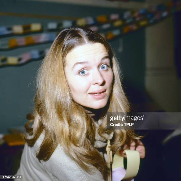View of Irish actress Sinead Cusack as she makes a paper chain during an unspecified event, London, England, November 15, 1978.