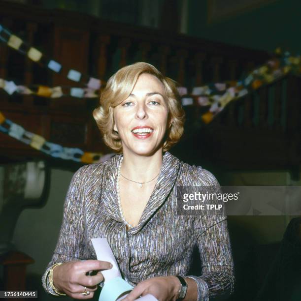 View of Australian actress Cassandra Harris as she makes a paper chain during an unspecified event, London, England, November 15, 1978.