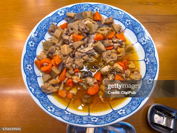 nishime, chikuzen style simmered chicken and vegetables serving dish at onsen hotel buffet banquet - chikuzenni stock pictures, royalty-free photos & images