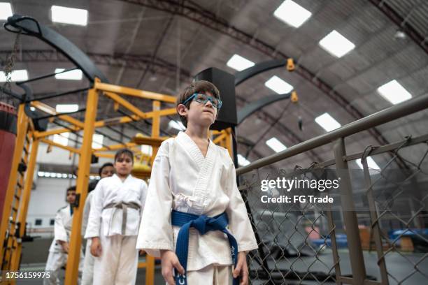 boy entering in a judo class at the gym - judogi stock pictures, royalty-free photos & images
