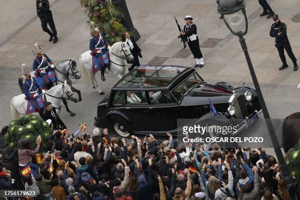 Spanish Crown Princess of Asturias Leonor waves to the crowd from her car as she leaves after attending a ceremony to swear loyalty to the...