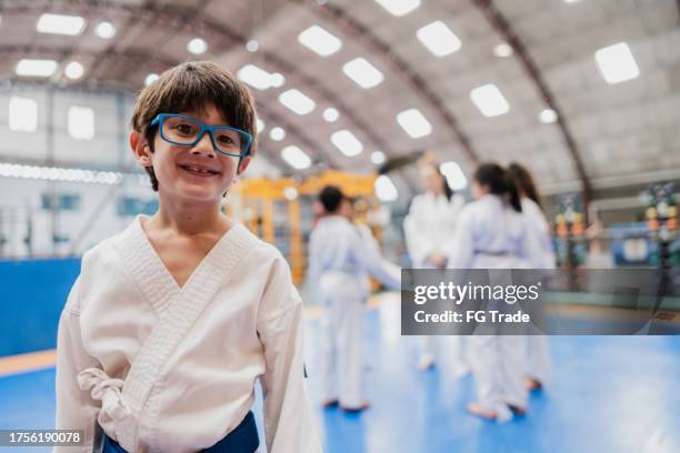 portrait of a boy in a judo class at the gym - karate stockfoto's en -beelden