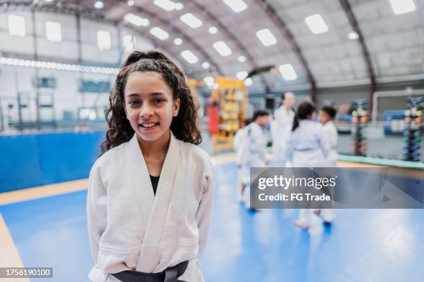 portrait of a girl in a judo class at the gym - jiu-jitsu stock pictures, royalty-free photos & images