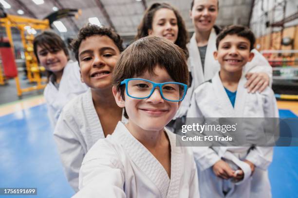 boy taking selfies with friends and sensei in a judo class at the gym - point of view - judo stock pictures, royalty-free photos & images