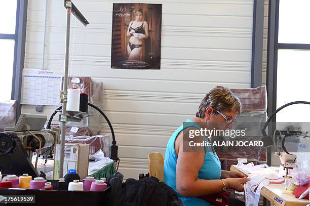 An employee of the "Indiscrete" lingerie brand manufactures a bra with a sewing machine on July 1, 2013 at the company's production site in...