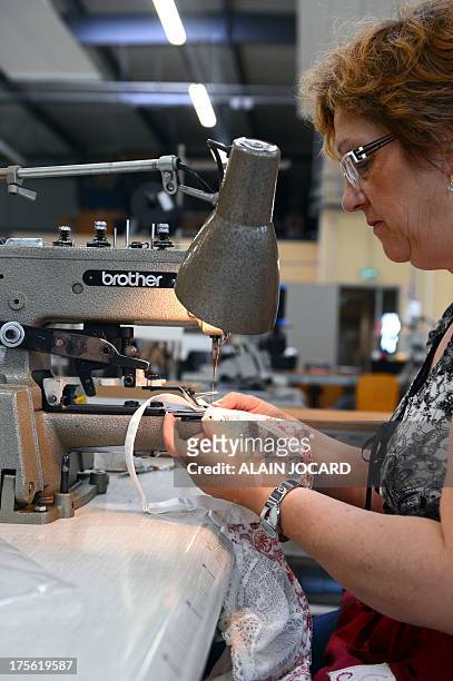 An employee of the "Indiscrete" lingerie brand manufactures a bra with a sewing machine on July 1, 2013 at the company's production site in...