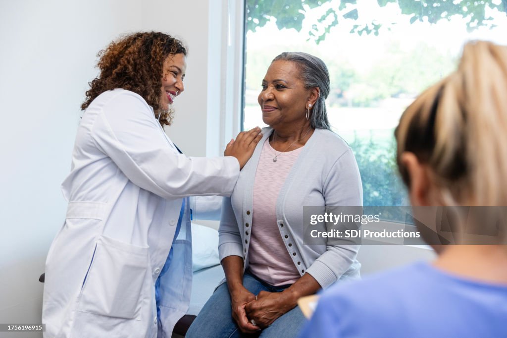 Female doctor smiles during medical examination of female patient