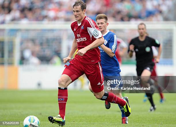 Marcell Jansen of Hamburg in front of Robert Bismark of Jena during the DFB Cup between SV Schott Jena and Hamburger SV at Ernst-Abbe-Sportfeld on...