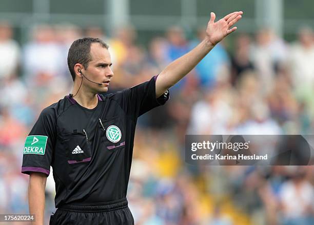 Referee Christian Leicher reacts during the DFB Cup between SV Schott Jena and Hamburger SV at Ernst-Abbe-Sportfeld on August 04, 2013 in...