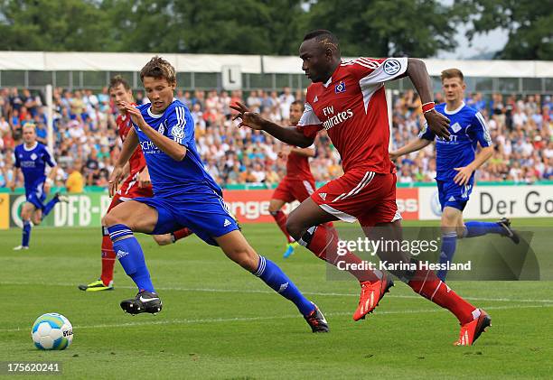 Robin Menzel of Jena and Jacques Daogari Zoua of Hamburg battle for the ball during the DFB Cup between SV Schott Jena and Hamburger SV at...