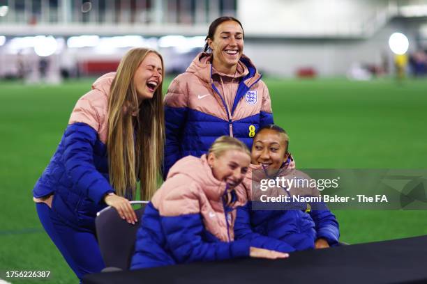 Hannah Hampton, Lucy Bronze, Chloe Kelly and Lauren James of England react during a commercial window at St George's Park on October 24, 2023 in...