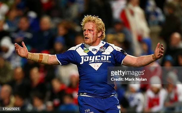 James Graham of the Bulldogs waits for assistance after being sent to the blood bin during the round 21 NRL match between the St George Dragons and...