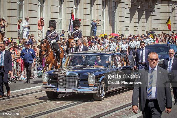 King Philippe and Queen Mathilde arrive at the Royal palace of Brussels in a Mercedes Pullman 600 convertible on July 21, 2013 in Brussels , Belgium.