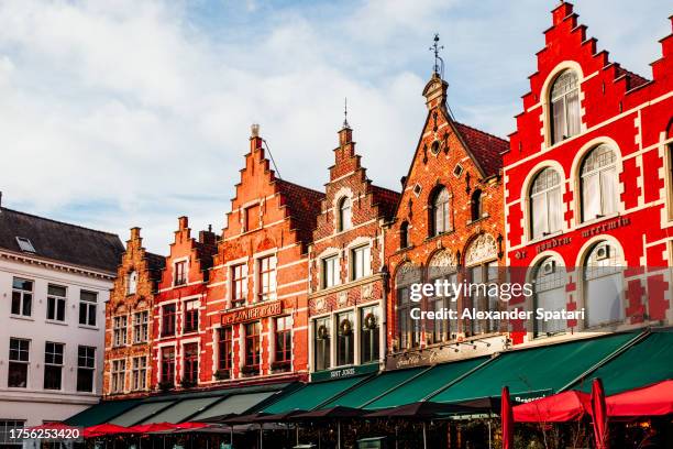 colourful houses at grote markt square in bruges, belgium - bruges stock pictures, royalty-free photos & images