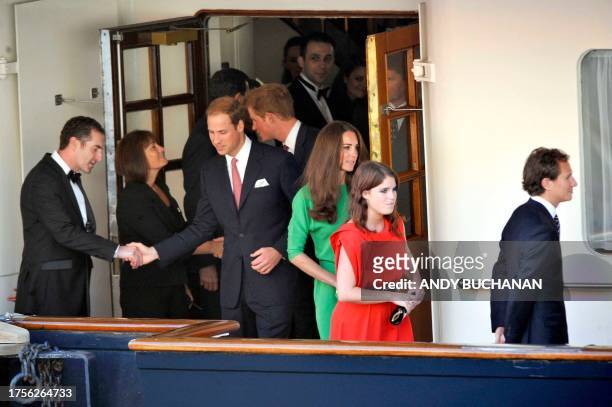 Prince William, Catherine and Princess Eugenie leave the pre-wedding drinks party of Queen Elizabeth II's eldest granddaughter Zara Phillips and her...