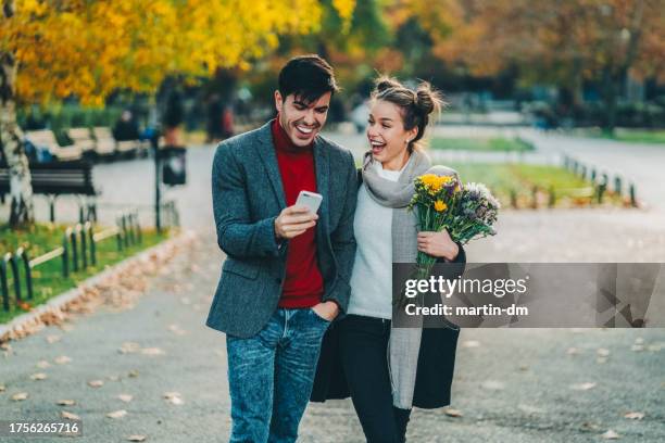 young couple dating in the park - romantic pics for her stock pictures, royalty-free photos & images