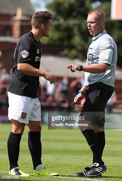 Referee Charles Breakspear makes a point to Gary Deegan of Northampton Town during the Sky Bet League Two match between York City and Northampton...