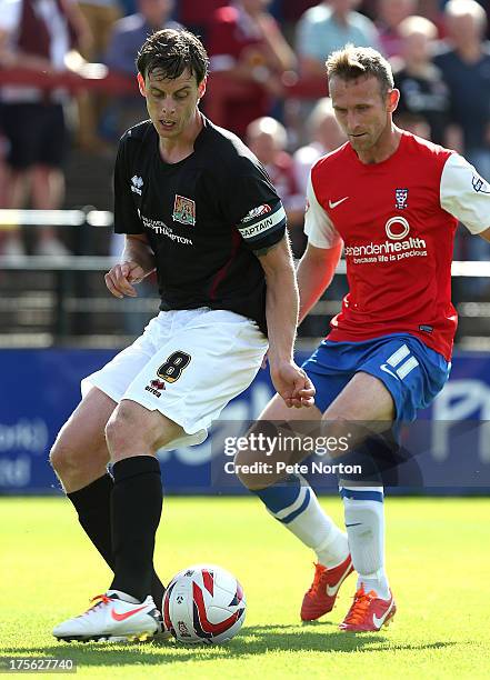 Ian Morris of Northampton Town looks to control the ball watched by Ryan Jarvis of York City during the Sky Bet League Two match between York City...