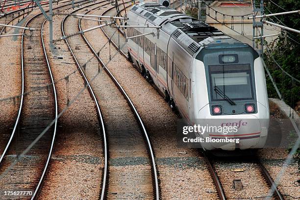 Train operated by Renfe Operadora SC arrives at Joaquin Sorolla trainstation in Valencia, Spain on Saturday, Aug. 3, 2013. Spain's state-owned rail...